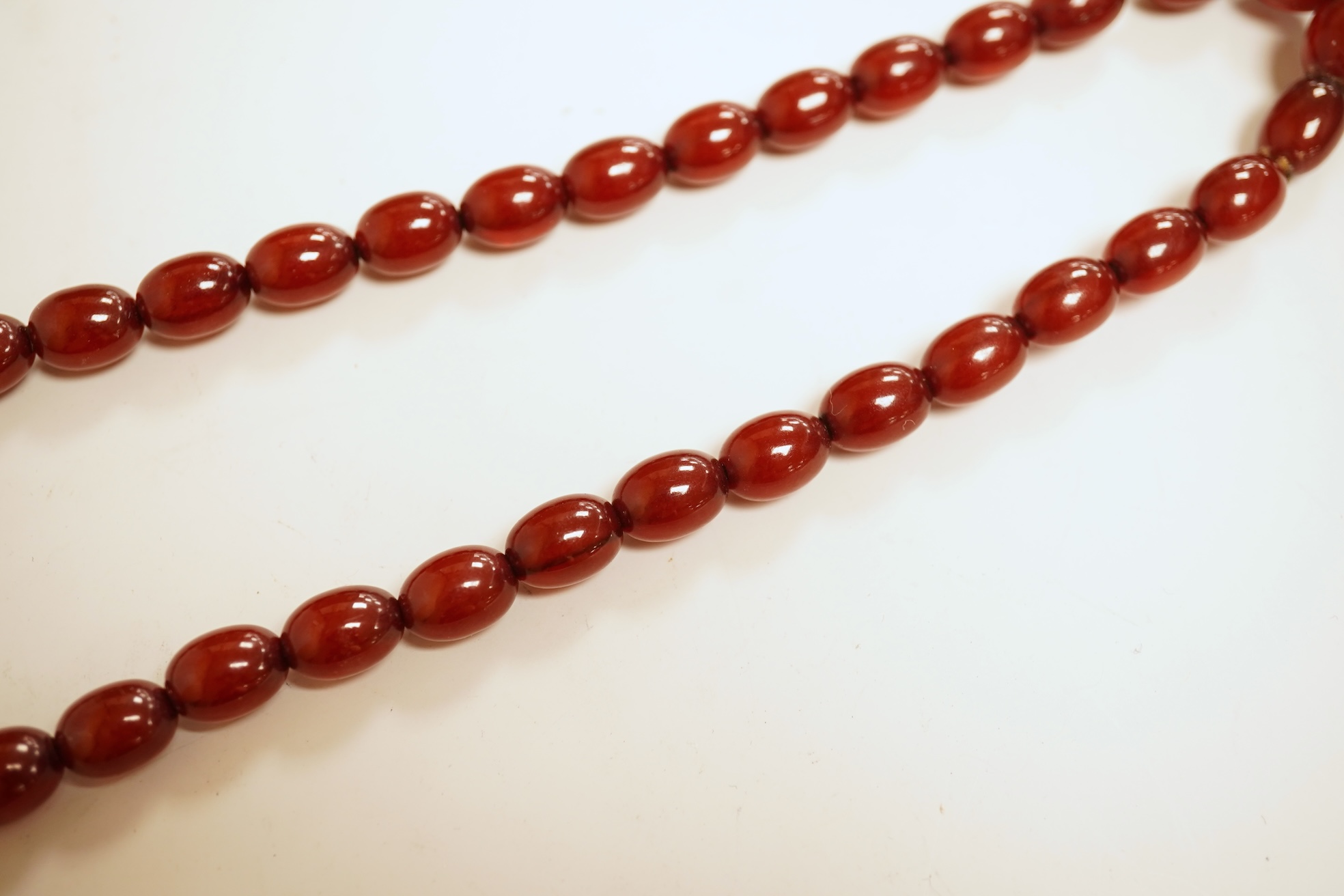 A single strand graduated simulated cherry amber bead necklace, 76cm, gross weight 75 grams.